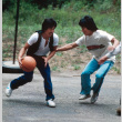 Gary Minamoto and Jeff Sasagawa playing basketball (ddr-densho-336-1284)
