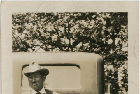 A man standing in front of a car (ddr-densho-321-531)