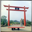 Man standing by Torii Gate at D. Hill Nursery (ddr-densho-377-1444)