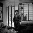 Man in robe, with name tag (ddr-densho-426-2476)