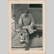 Man with Miki Domoto outside barracks (ddr-densho-329-1292)