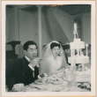 Henri Takahashi and Tomoye (Nozawa) Takahashi seated at head table with wedding cake (ddr-densho-410-494)
