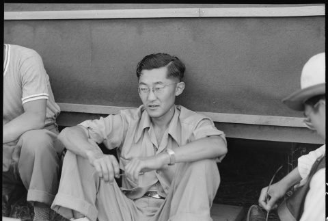 Japanese Americans sitting outside barracks (ddr-densho-151-279)
