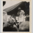 Man in apron standing on stage or back of truck (ddr-densho-466-414)