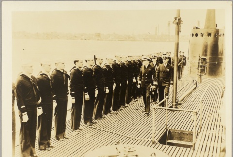 Navy crew saluting officers on the deck of a submarine (ddr-njpa-13-149)