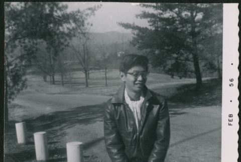 Young man sitting on bollard (ddr-densho-523-265)