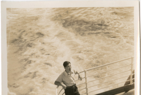 Henri Takahashi leaning on railing on board ship (ddr-densho-426-2070)