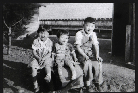 Three children sitting (ddr-densho-433-555)