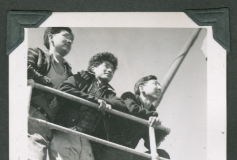 3 men peering over railing (ddr-densho-540-101)