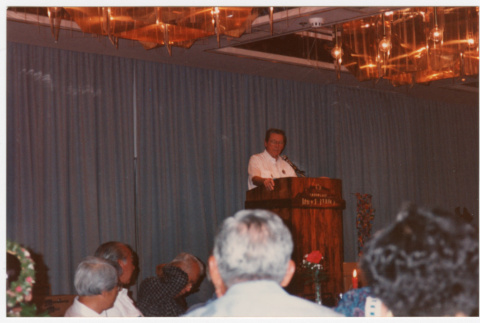 Man speaking at podium (ddr-densho-368-380)