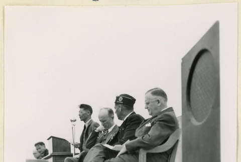 Men stand on a stage (ddr-densho-37-1145)