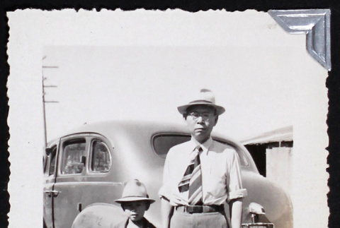 Man and boy stand beside a car (ddr-densho-404-71)