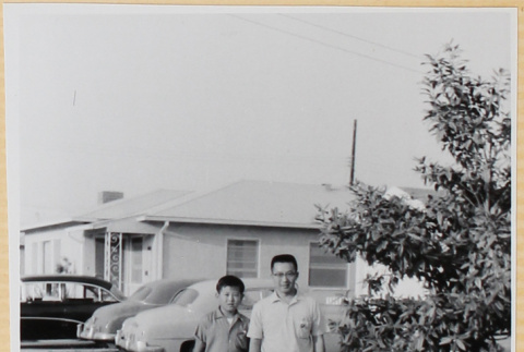 Man and boy in yard outside house (ddr-densho-522-61)