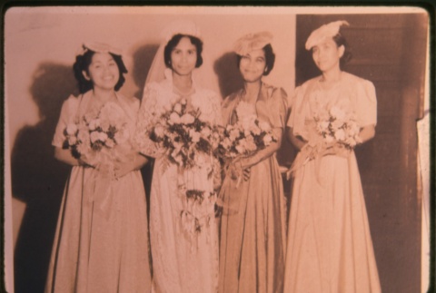 Four women in dresses holding flowers (ddr-densho-330-144)