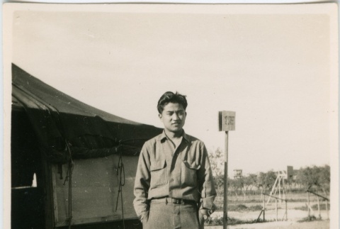 Man in military uniform outside a tent (ddr-densho-201-38)