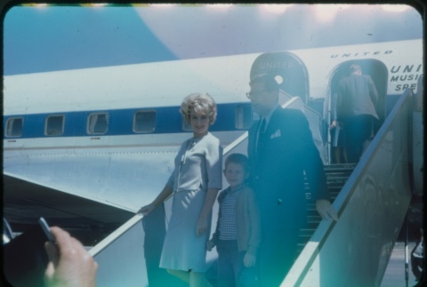 A man, woman, and child deboarding a plane (ddr-densho-338-515)
