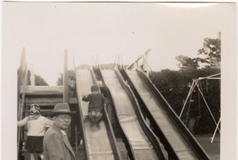 Boy on slide on playground (ddr-densho-426-39)