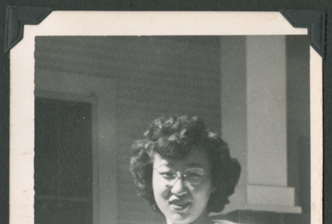 Woman outside next to a flower (ddr-densho-471-125)
