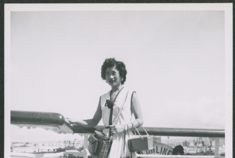 Nisei woman poses on board ship (ddr-densho-363-75)
