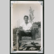 Teenage boy sitting on bleachers (ddr-densho-550-138)