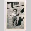 Toddler standing by barracks wall (ddr-densho-329-1338)