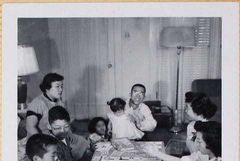 Group playing Monopoly (ddr-densho-522-550)