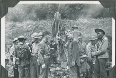 Group of men around small campfire (ddr-ajah-2-252)