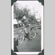 Photo of Paul Ima riding a bicycle (ddr-densho-483-1347)