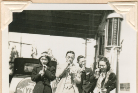 Photo of group drinking sodas outside a gas station (ddr-densho-341-76)