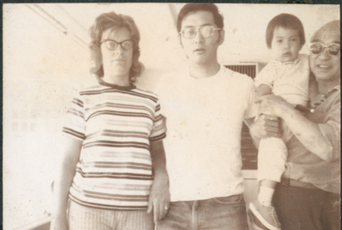 Chester Sakura holding baby with younger couple (ddr-densho-523-581)