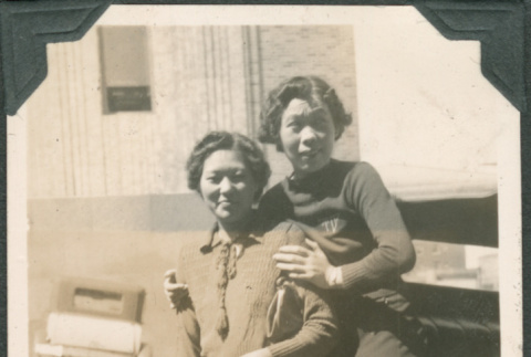 Two women next to car (ddr-densho-316-359)