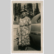 Photo of an elderly woman by a car (ddr-densho-483-1207)