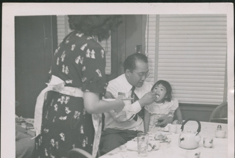 Man feeding small girl (ddr-densho-293-146)