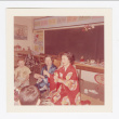 Lillie Komai teaching students and Mrs. Cole how to use chopsticks (ddr-densho-562-71)