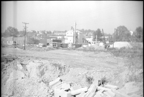 Dirt road with broken concrete and building in background (ddr-densho-377-1509)