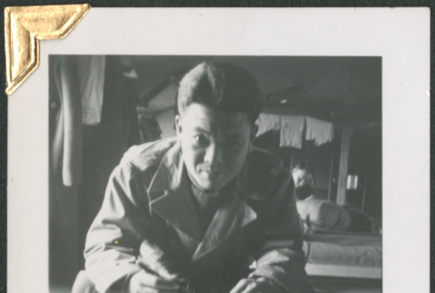Man sitting on cot, writing (ddr-densho-434-65)