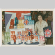 Tomoye Takahashi standing by display of British themed products (ddr-densho-426-1091)