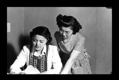 Helen Hayashigawa and Shizo Hamatani in the Amache Co-op office (ddr-csujad-55-1545)