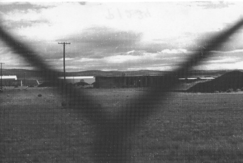 [Incarceration camp as seen through a fence] (ddr-csujad-29-197)