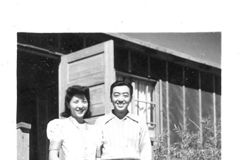 Nisei man and woman in front of barracks (ddr-densho-157-33)