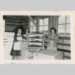 Women pose with ship models at a shipping department (ddr-densho-37-1259)