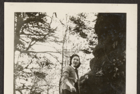 Woman standing on a tree (ddr-densho-287-70)