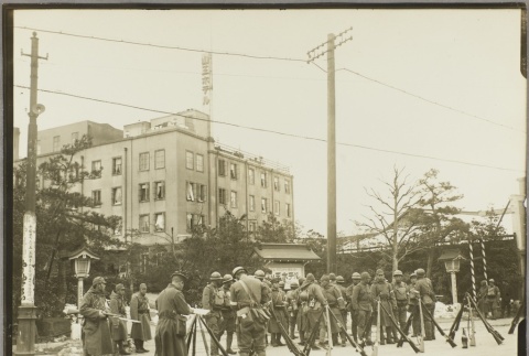 Soldiers standing near propped up rifles (ddr-njpa-13-1428)