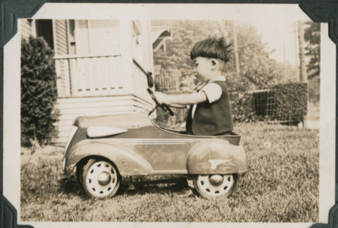Boy in toy car (ddr-densho-355-483)