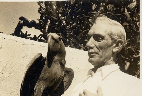 Honolulu ornithologist posing with a bird (ddr-njpa-2-605)
