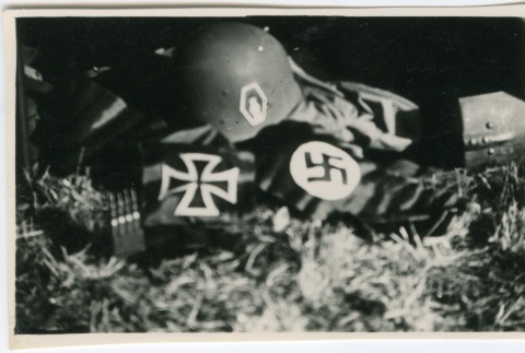 Military gear on the ground showing swastikas and crosses (ddr-densho-201-35)