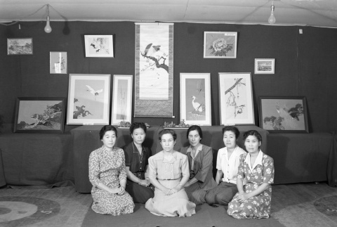 Women sitting in front of an art exhibit (ddr-fom-1-689)