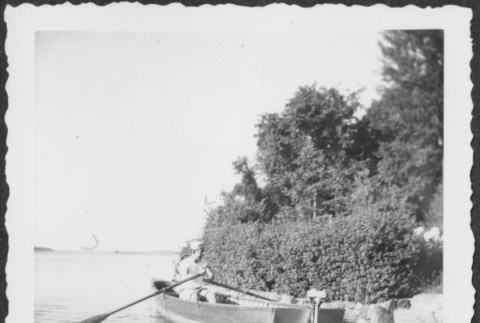 Man in uniform rowing a boat (ddr-densho-434-409)