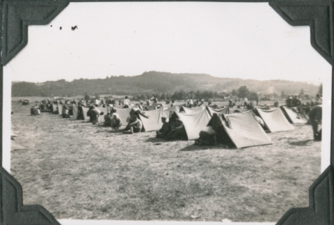 Men sitting outside row of tents (ddr-ajah-2-224)