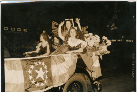 Three women in parade car with flag with 14 stars (ddr-densho-426-2085)
